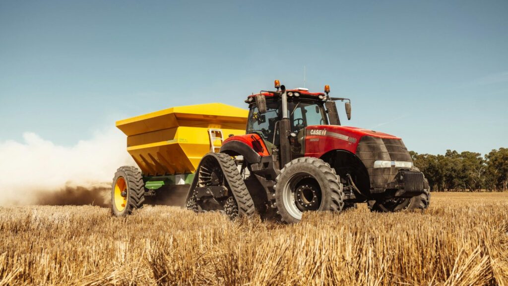 Tractor pulling wagon in wheat field